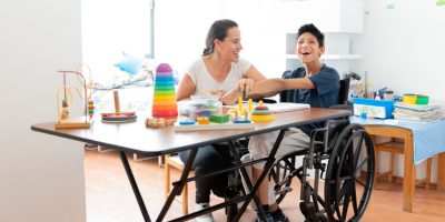 Mother drawing with son with Cerebral Palsy